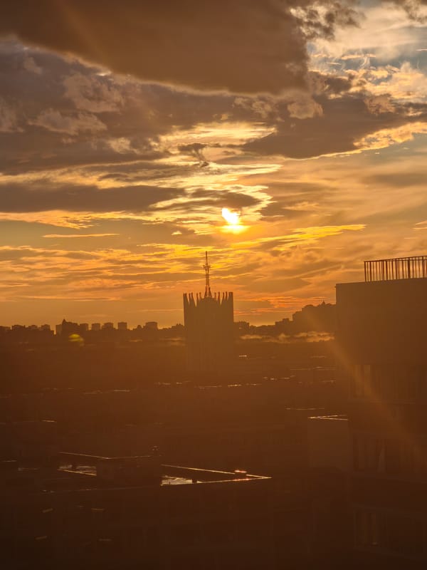 City skyline sunset, clouds lit up in warm evening light
