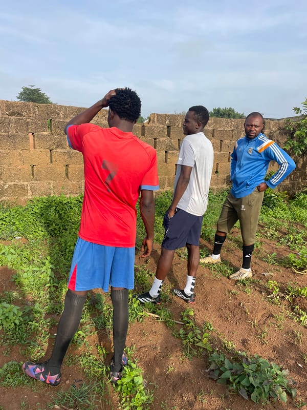 Morning activity at a dirt soccer field in Gura Top, Nigeria