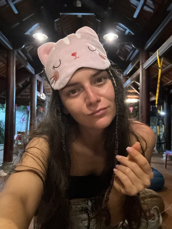 Woman photographed with pink cat mask in Mũi Né indoor space