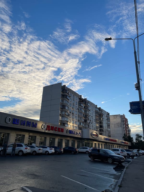 Moscow side street, auto shops and apartment blocks on a June afternoon