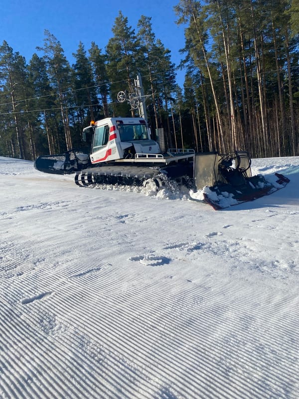 Snow groomers prepare ski slopes in Russian resort