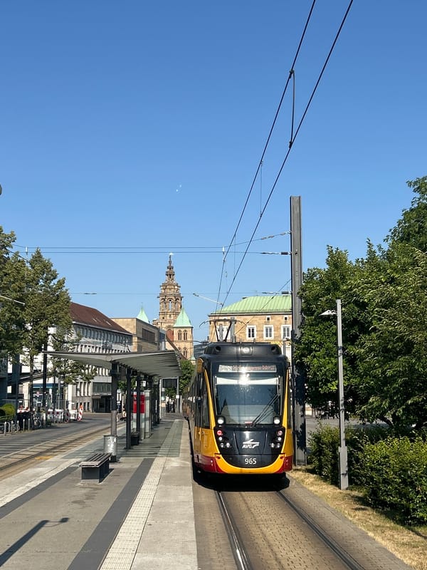 Tram 965 at a Heilbronn stop, with street life nearby