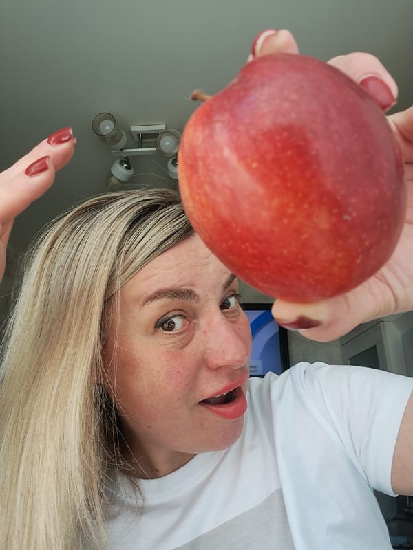 Woman displays red apple to camera in Russia