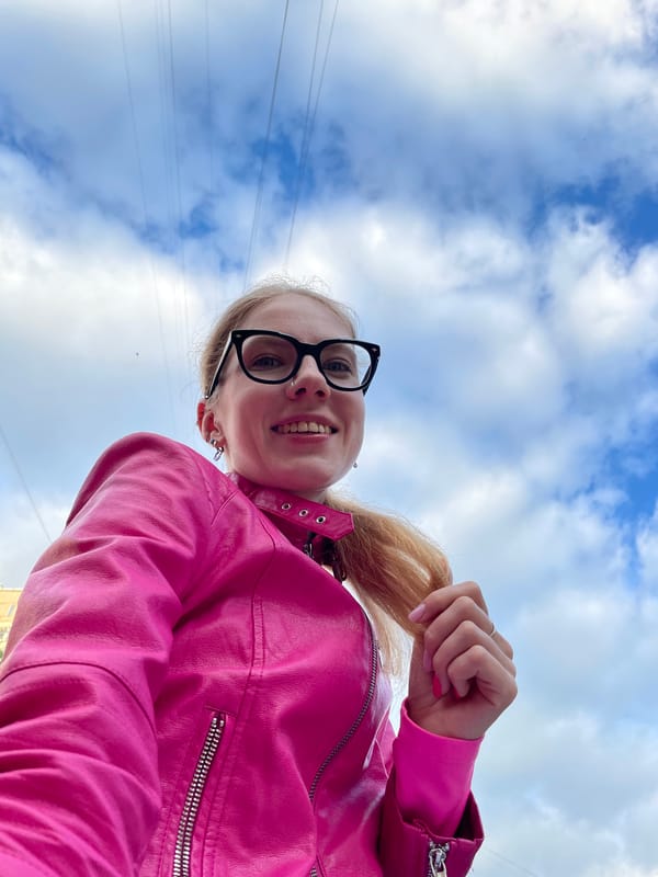 Woman photographs herself among pink peonies in Izhevsk