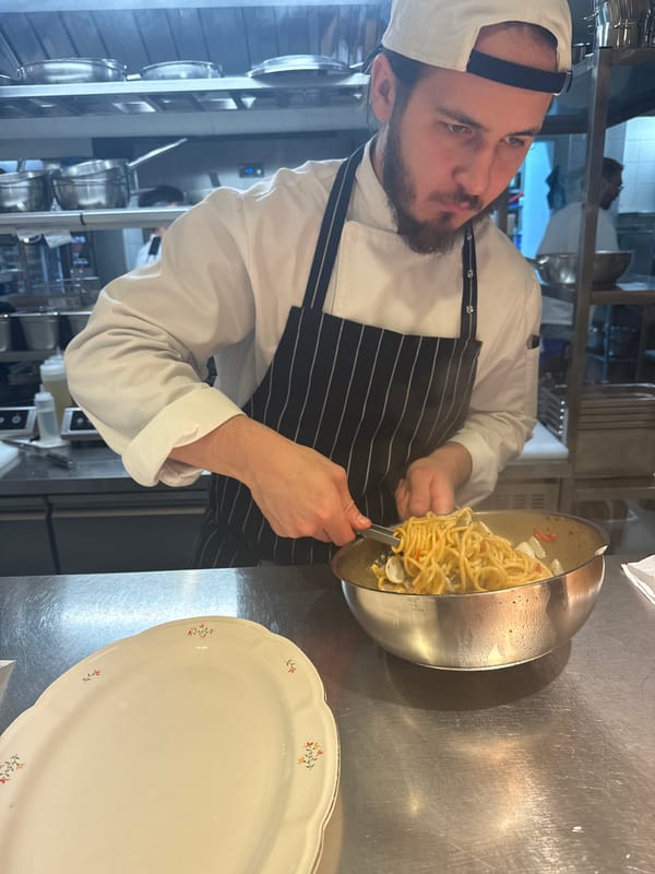 Chef prepares plated dishes in professional kitchen