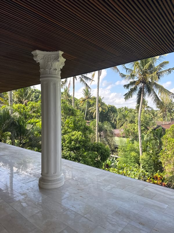 Classical column spotted amid tropical landscape in Tampaksiring