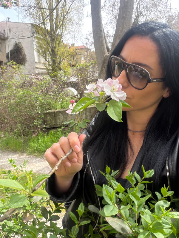 Woman enjoys spring blossoms in Pleven park