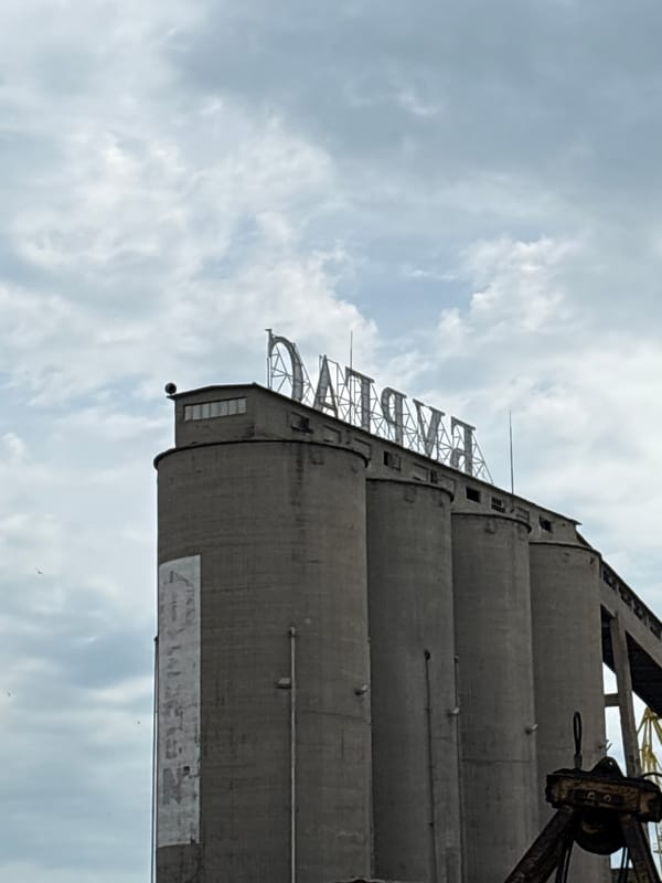 Industrial harbor scenes: cargo ships, grain silos, and dockside detail