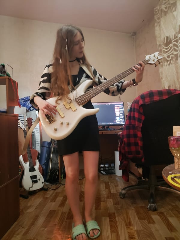 Barefoot bass guitar session in a casual indoor setting
