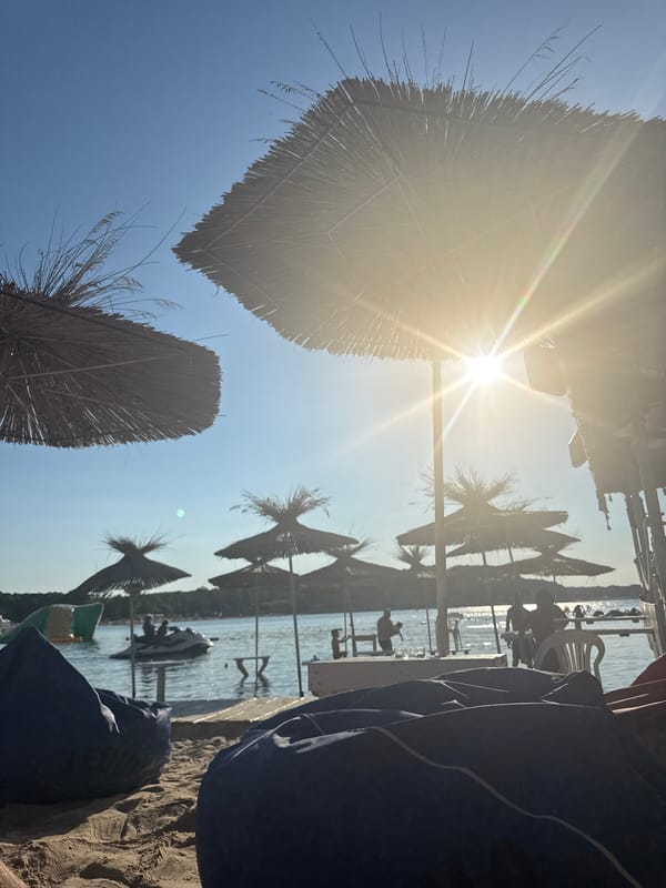 Thatched umbrellas and beanbags on a sunny Kiten beach
