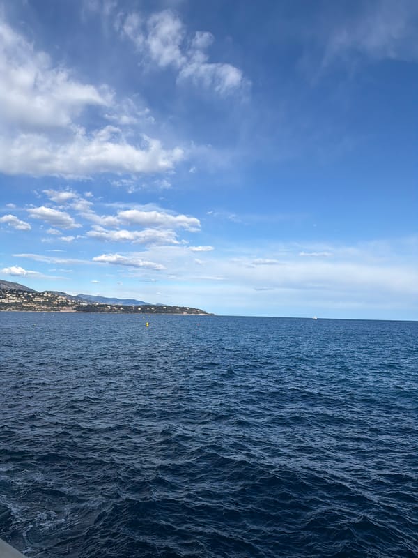 Clear skies over Monaco coastline and superyacht at Port Hercule