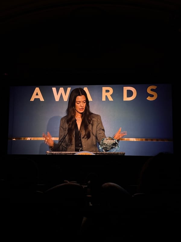 Formal awards ceremony or theater event documented by witnesses