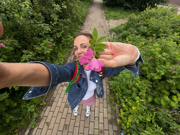 Playing with a pink wildflower on a Birobidzhan street