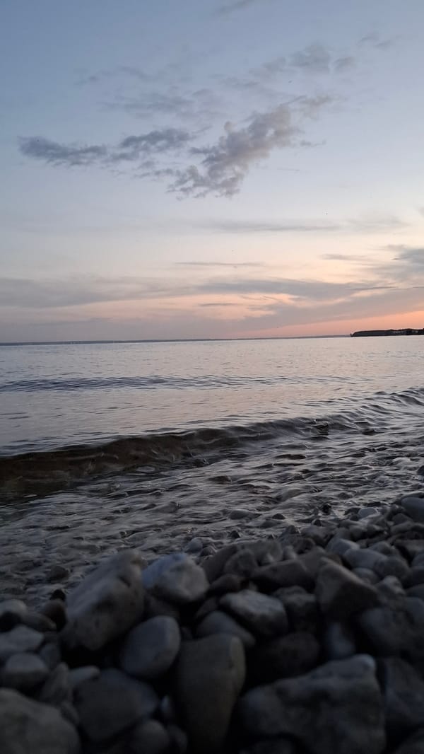 Dusk to moonlit night at a quiet beach shoreline