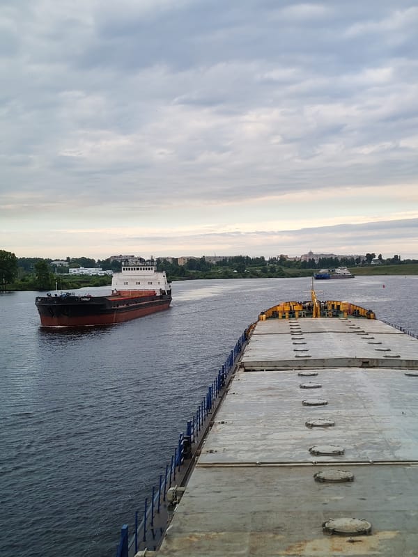 Russian cargo barges navigate a river lock system