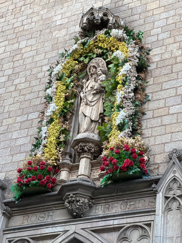 Barcelona streets: a carved niche and a view toward Tibidabo