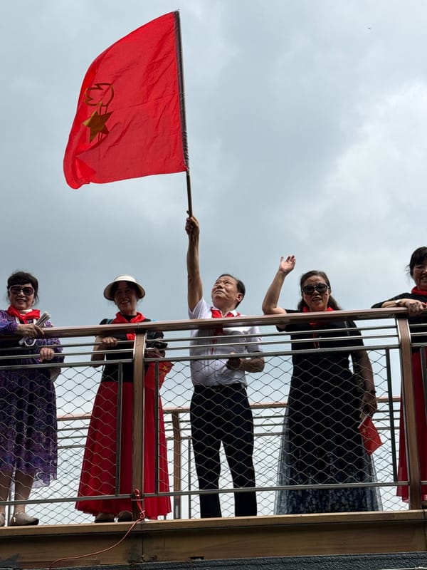 Group gathers on balcony with Chinese flag in Chongqing