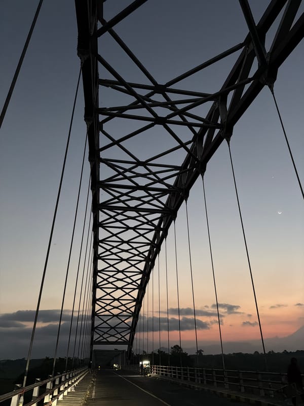 Suspension bridge at dusk, Selokanayar — steel and fading sky