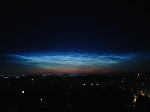 Noctilucent clouds glow over Kolpino on a July night