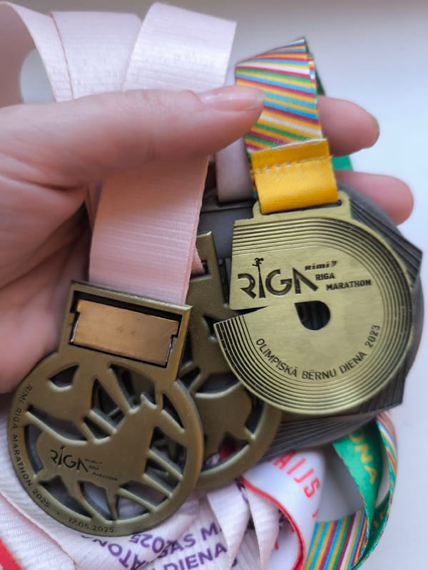 Runner displays Riga Marathon medal collection in Latvia