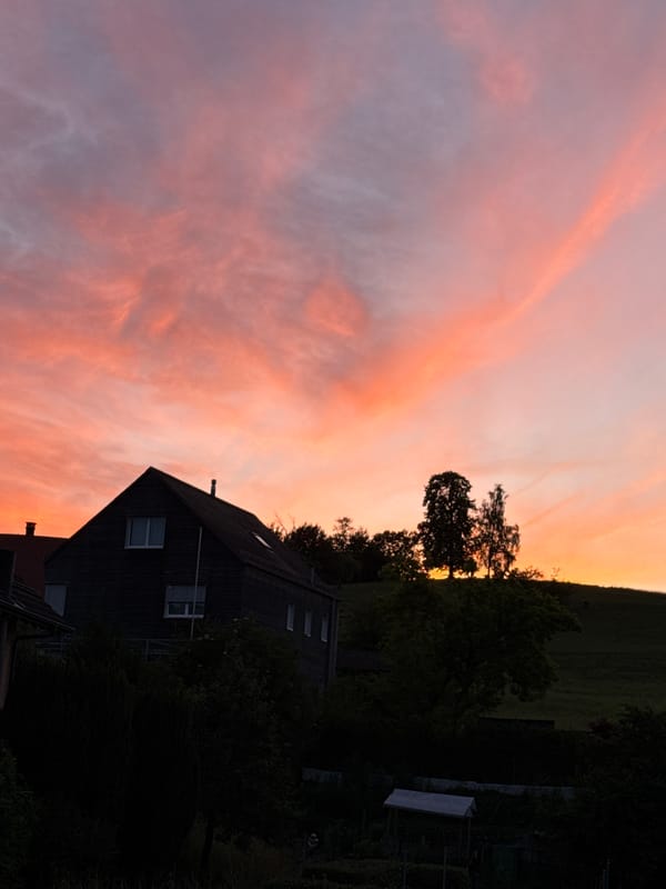 Sunset colors paint the sky over Lufingen, Switzerland