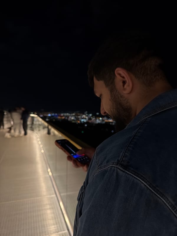 Man uses phone on illuminated observation deck in Krasnoyarsk