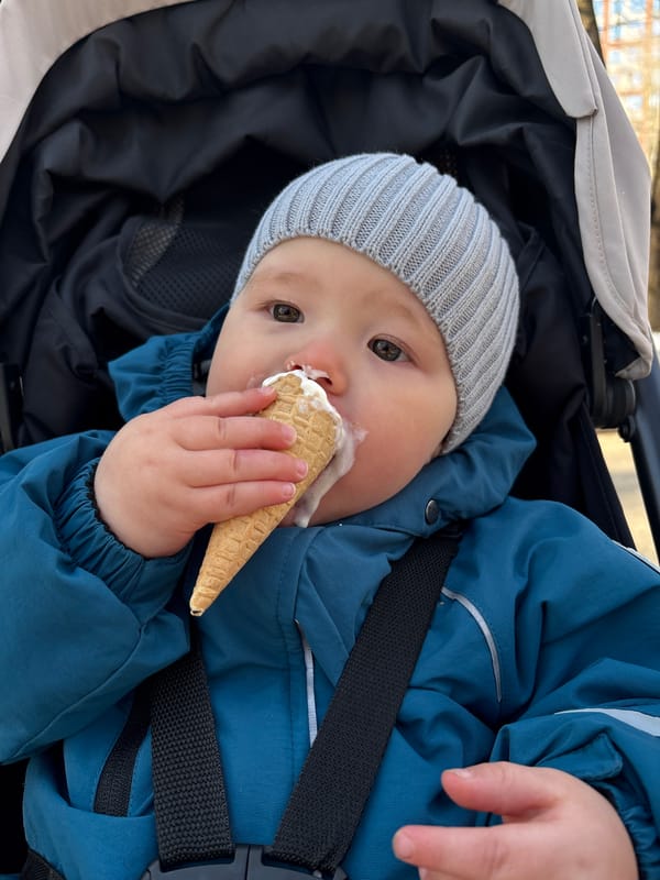 Child enjoys ice cream in stroller in Izhevsk