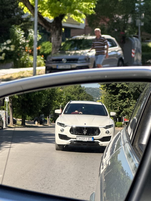 Street scene in Veliko Tarnovo featuring two contrasting SUVs