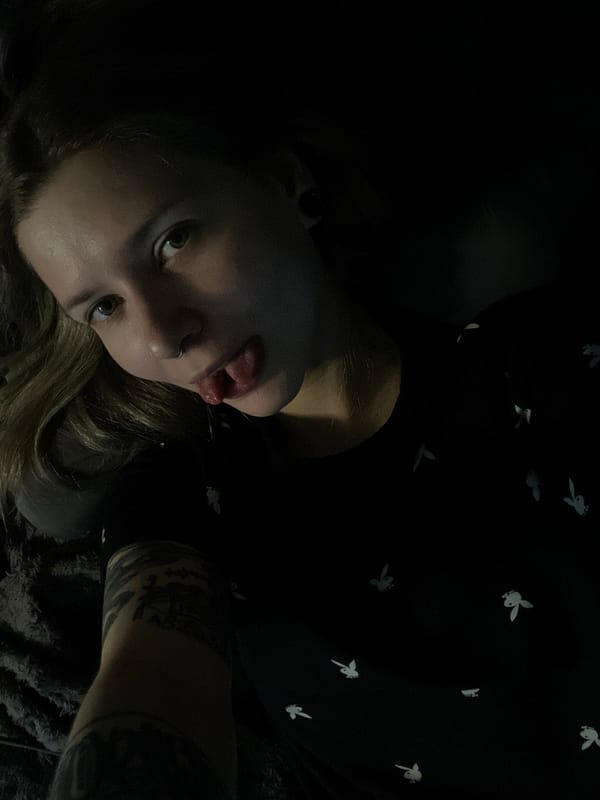 Woman poses for photo in low-lit environment in Khimki