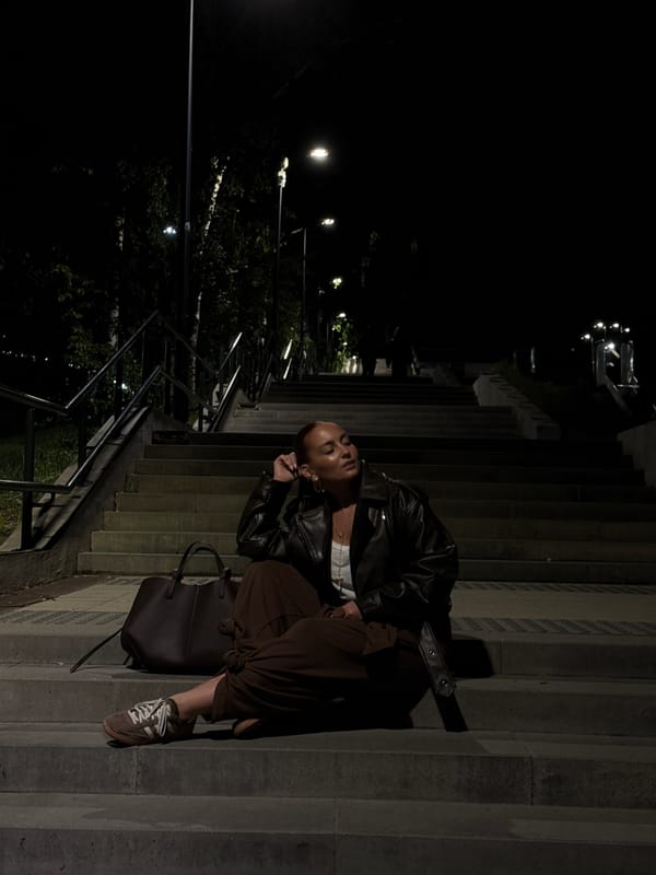 Women gather at illuminated monuments in Izhevsk during evening