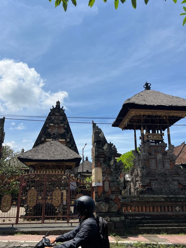 Balinese artisans craft wooden sculptures in predawn Ubud workshop