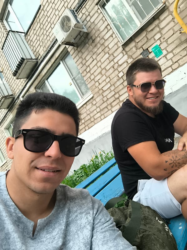 Urban memories captured: men on bench, sky, selfie, lighter