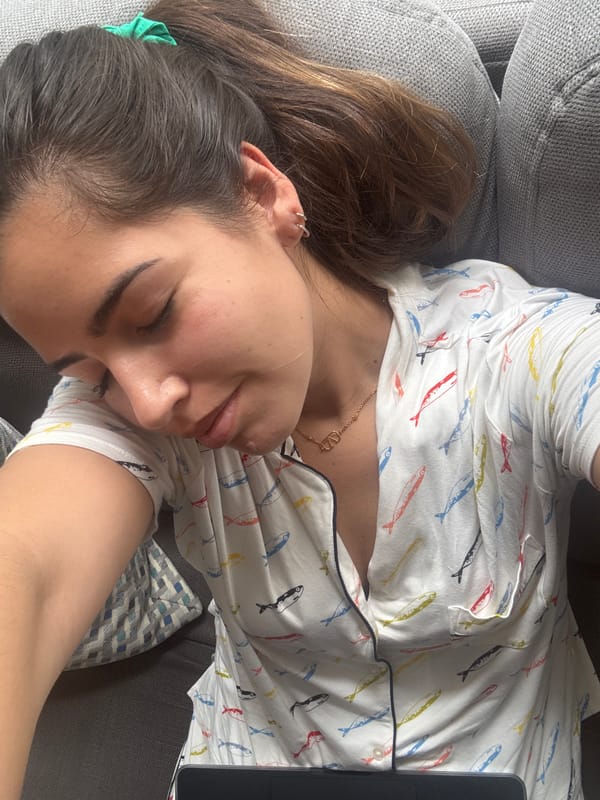 Woman rests on couch with laptop in Mexican home
