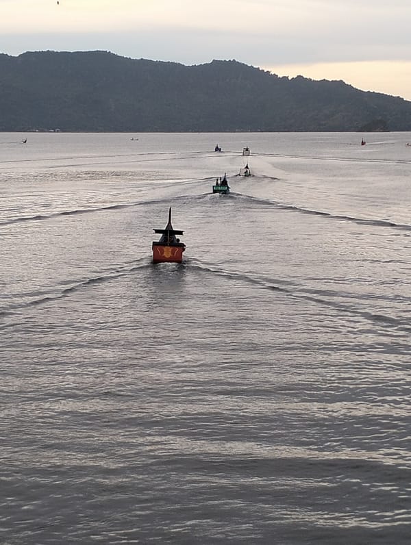 Small boats navigate calm waters near Banda Aceh coastline