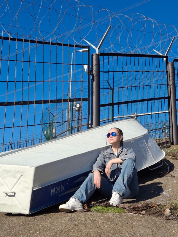 Person sits on boat by water in Chaikovsky Russia