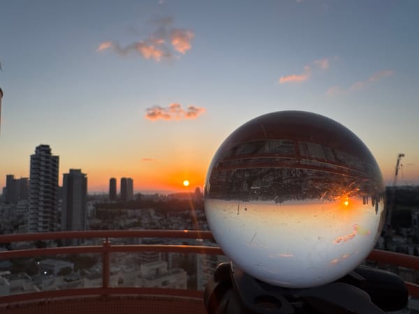 Sunset observed through glass sphere over Ramat Gan cityscape