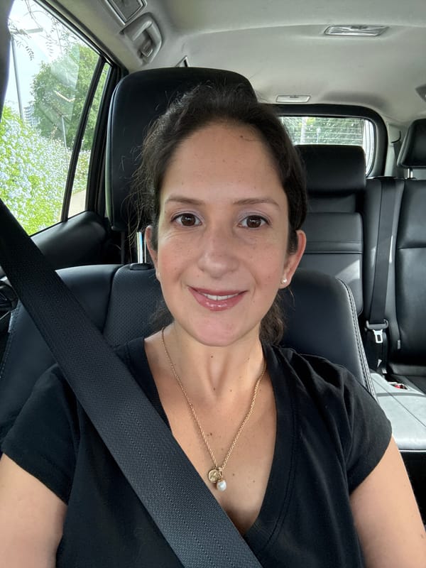 Woman photographed smiling in driver's seat in San Isidro