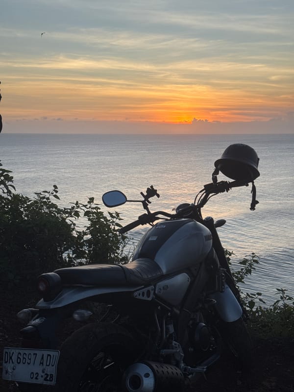 Motorcycle sunset ride documented along coastal cliffs and scenic roads