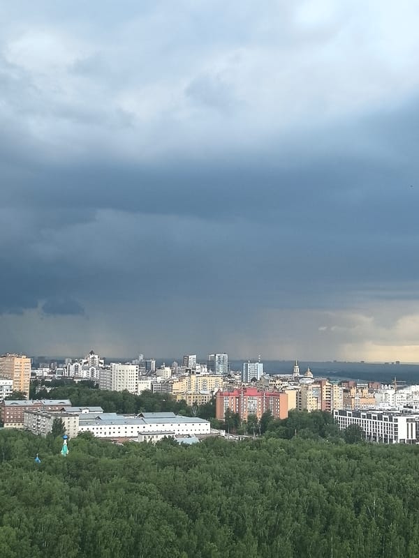 Storm clouds gather over Perm city and forest canopy