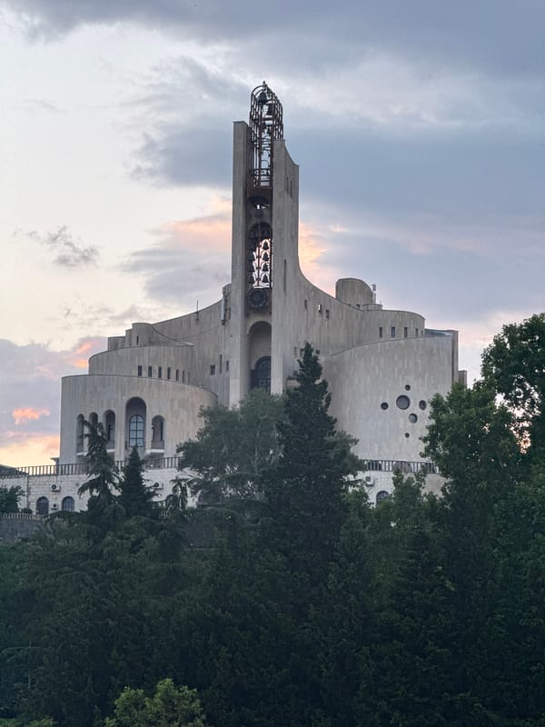 Tbilisi landmarks: Sameba Cathedral and a dam-top building