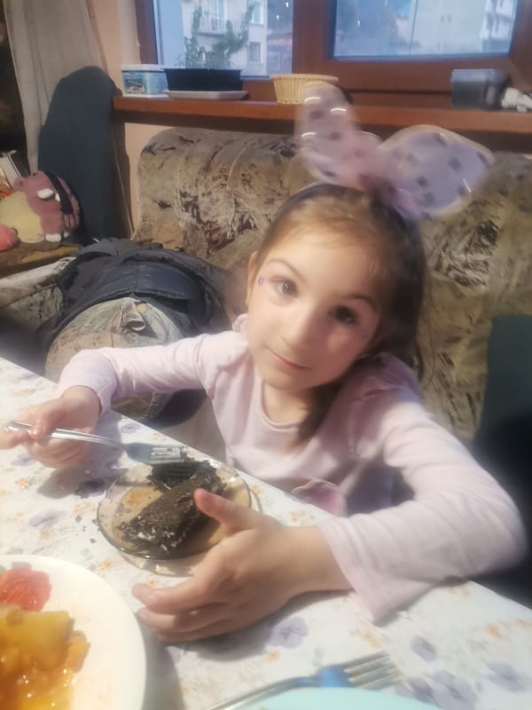 Children enjoy cake at home in Obrochishte, Bulgaria