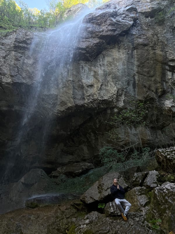 Visitors explore waterfall and caves near Veselinovo, Bulgaria