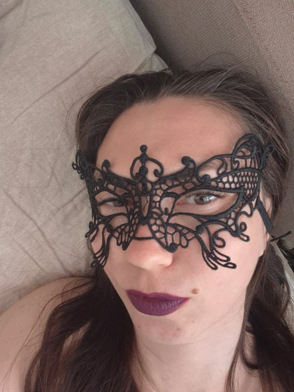 Woman photographed in intimate indoor portrait session with accessories