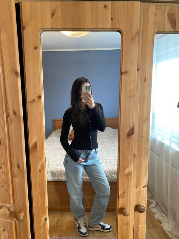Woman takes mirror selfie in Björklinge home