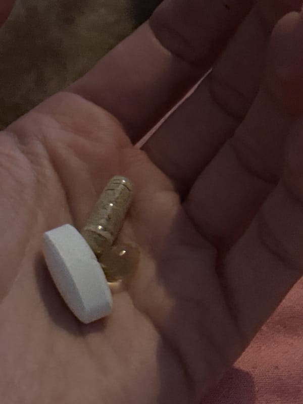Person holds two different pills in Amsterdam