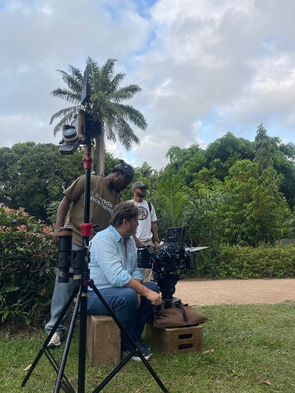Film crew shoots outdoor scene with camera equipment