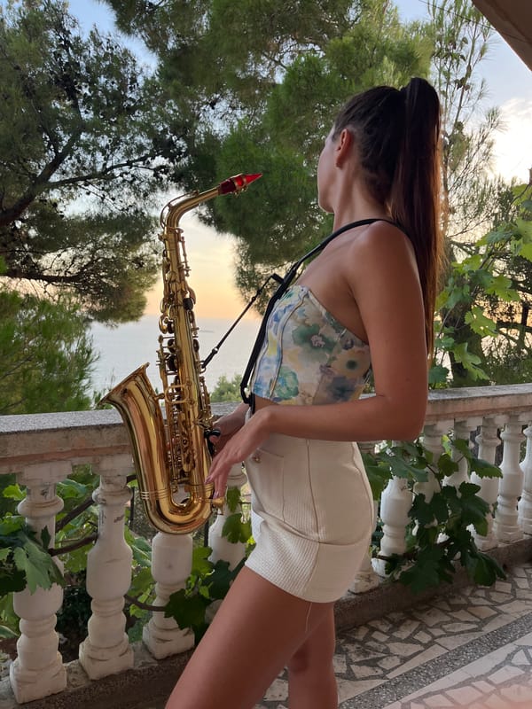 Saxophone on a Montenegrin balcony at sunset, cats included