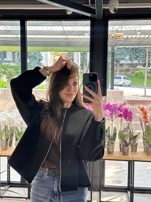 Woman takes selfies during early morning flower shop visit