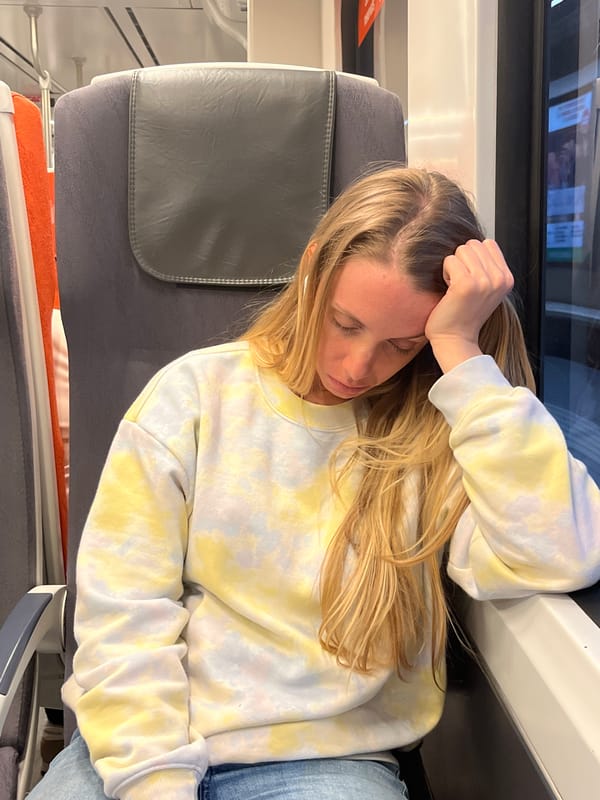 Woman sleeps on train in Barcelona