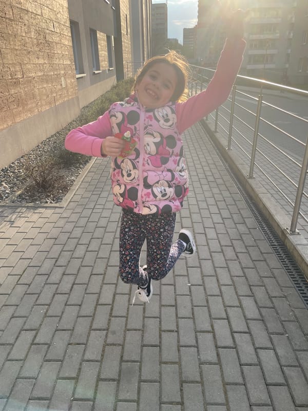 Girl photographed outdoors as helicopter flies overhead